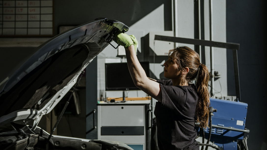 five things that can slow down the vehicle assembly line Hero image of a woman working